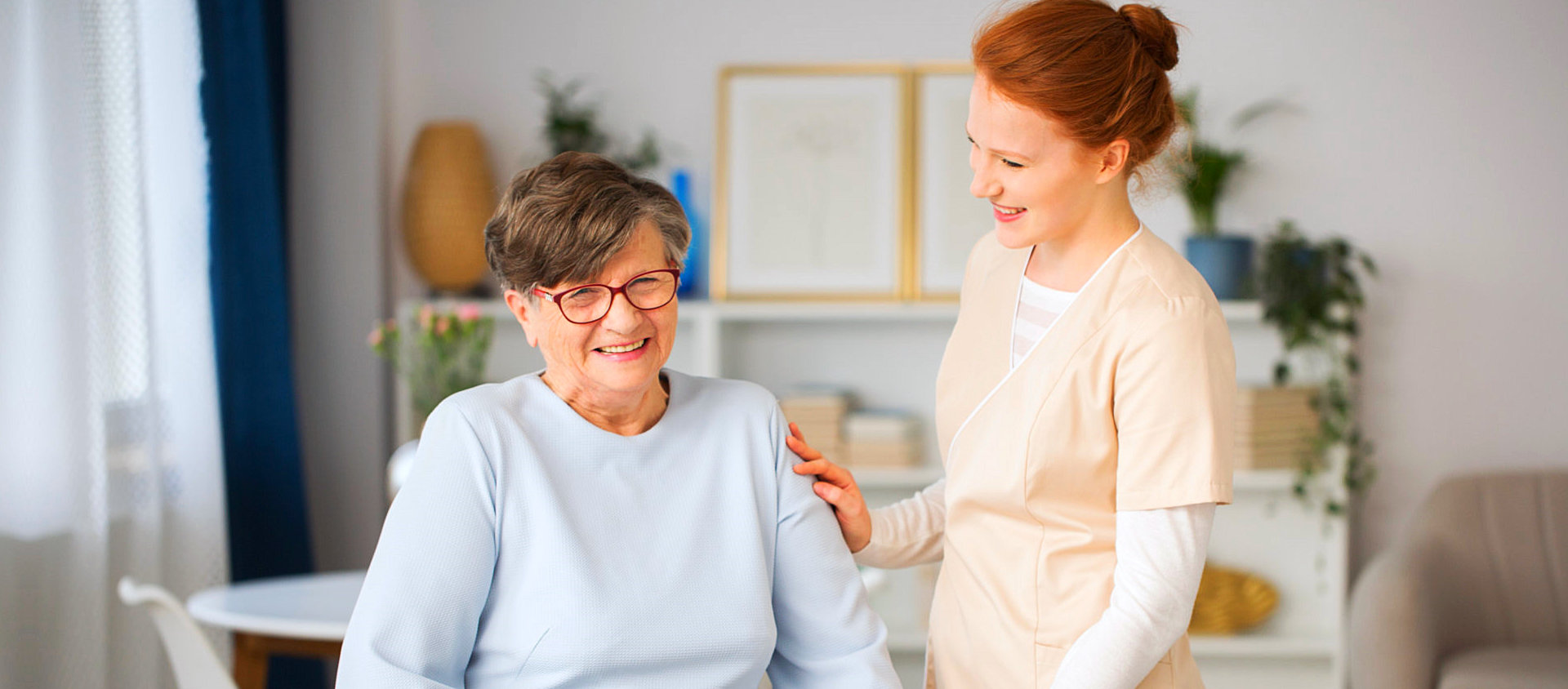 caregiver and senior woman are smiling