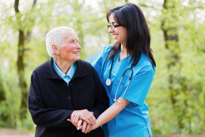 nurse and senior woman are smilng