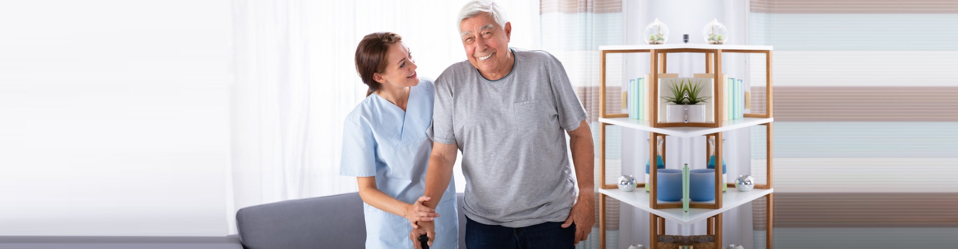 nurse assisting senior man to walk