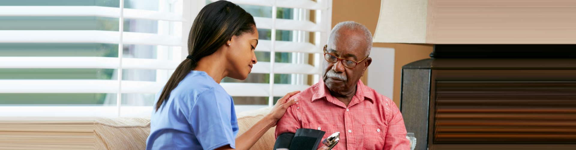 nurse monitoring the blood pressure level of senior man